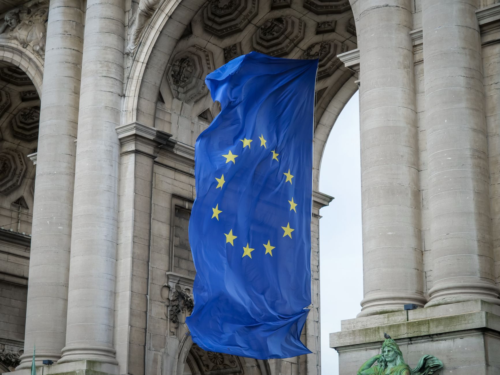 The European Union flag flying beneath the Cinquantenaire Arch in Brussels